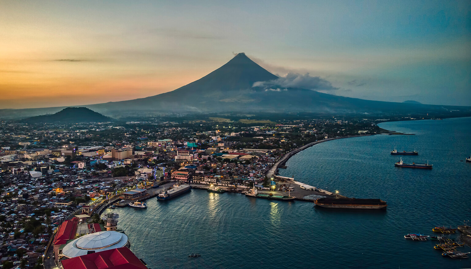 Sun setting over a coastal city.