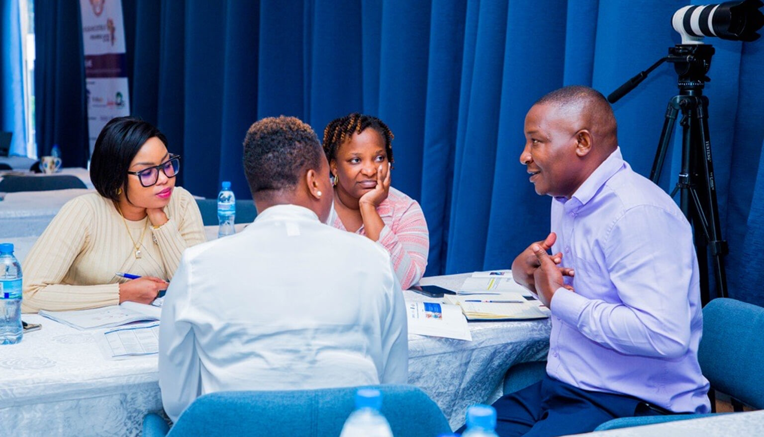 Team sitting around a desk working together.